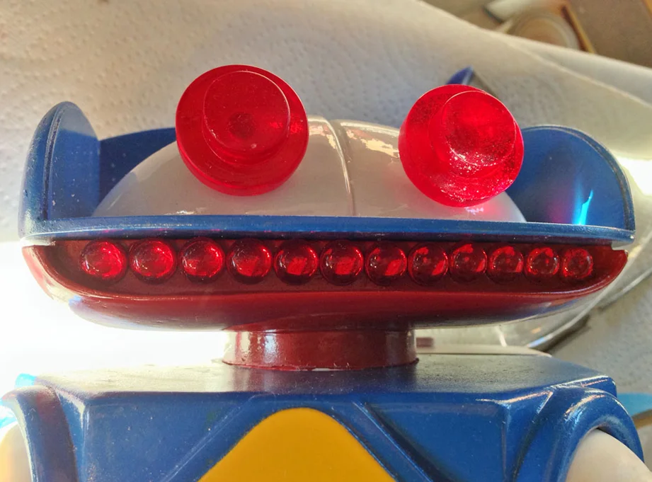 Twelve cabochons were glued into the mouth. The ends had to be notched to allow the mouth shield to slide by.