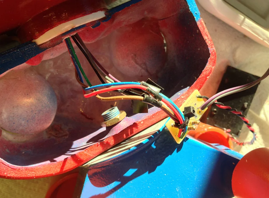 I cut the wires of the electronics and fed them through the neck hole. Inside the torso, I re-soldered them to the switch and power supply.