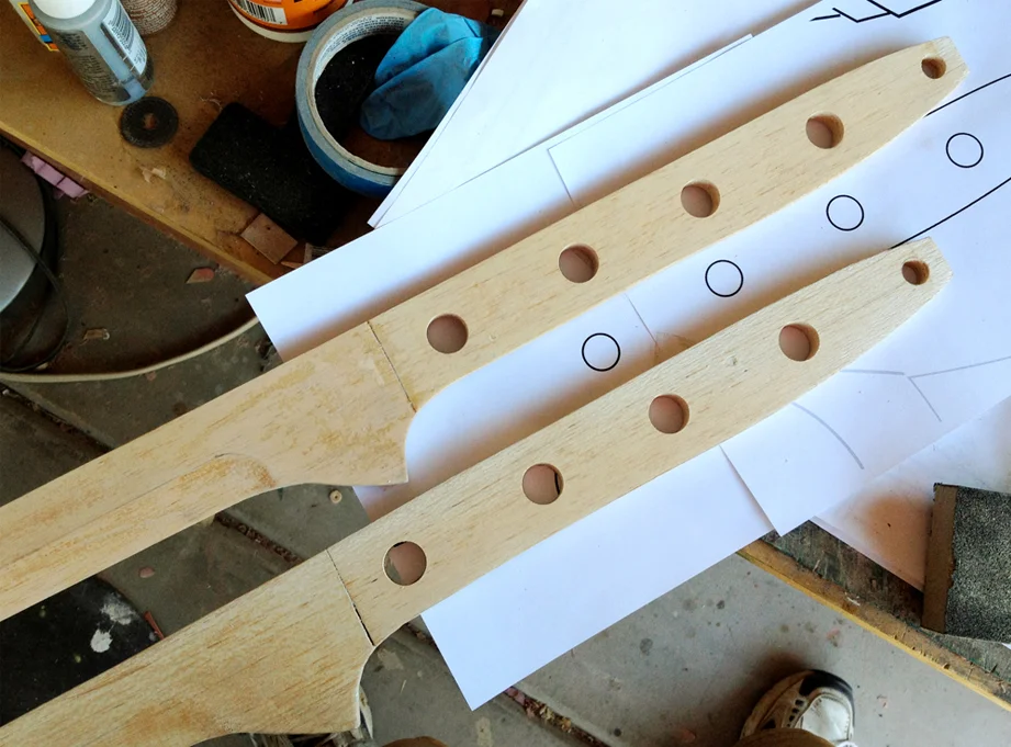 I drilled the holes in the handle which removed more weight. Now that the shaping was done, I coated the entire thing in more fiberglass resin. It soaks into the wood and significantly hardens it. The dried surface was then sanded smooth, with any pits filled by spot filler putty. By the time I was done, the 4 foot blade only weighted 4 ounces!