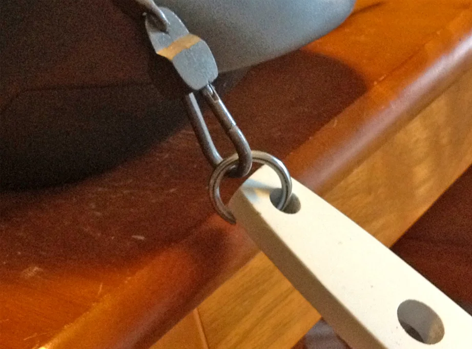 The ring was threaded into the blade hole with pliers and then it snaps right into the spring link!