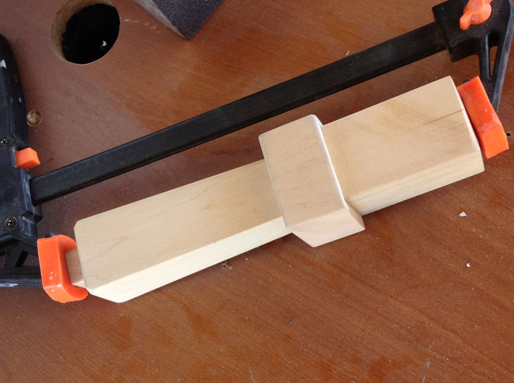 A bit of wood glue and pressure from a clamp completes the base.