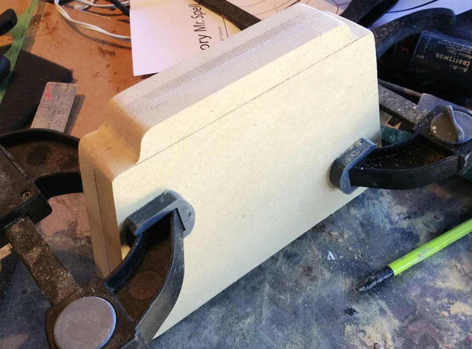 I glued the 3/4″ and 1/4″ pieces together to make two halves. Clamping both sides allowed me to sand the edges to make the fit perfect.