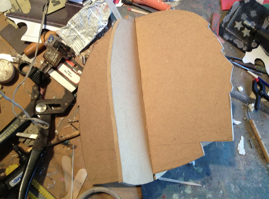  I started by cutting profiles of the helmet from 1/4″ MDF to act as guides while I sculpt. I cut slots in each and slid them together. 