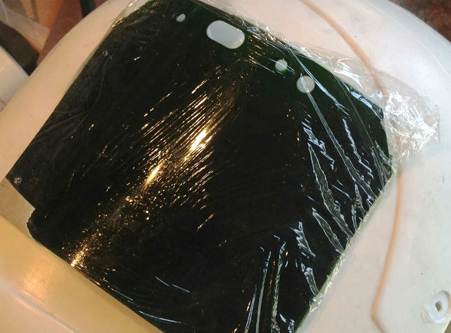 Since I’ll be attaching it before painting, I covered the visor with plastic wrap.