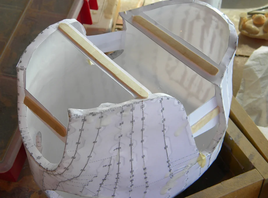The paper spacers weren't holding the shape so I glued mixing sticks to them before slushing several coats of plastic resin inside.