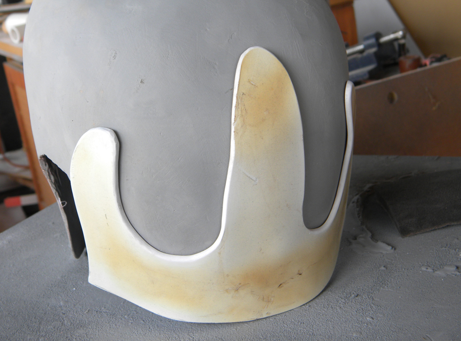  I heated up some thick styrene and shaped it to the back of the helmet to form this plate. Orcish craftsmanship means I don't have to worry about it being close to perfect! 