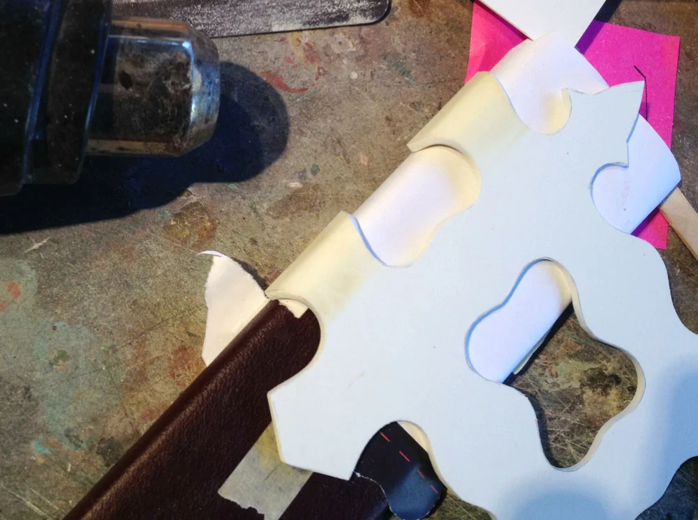 Concurrently, I started working on the cuff at the opening of the scabbard. I cut thick styrene to shape and heat formed it around the scabbard.