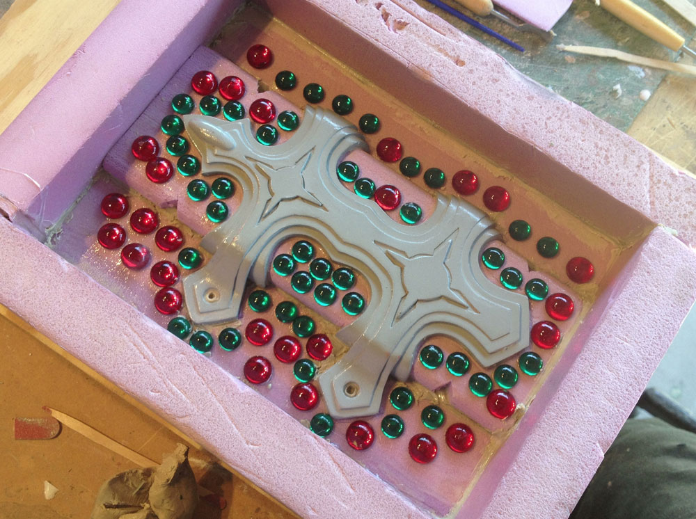  I poured silicone for each side. Acrylic cabochons were used for keys to align the mold parts. 