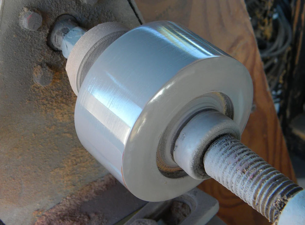 After the ends were shaped, I slowed the lathe down and sanded it up to 1000 grit. Finally, I sprayed it with filler primer and buffed it to a shine with a paper towel.