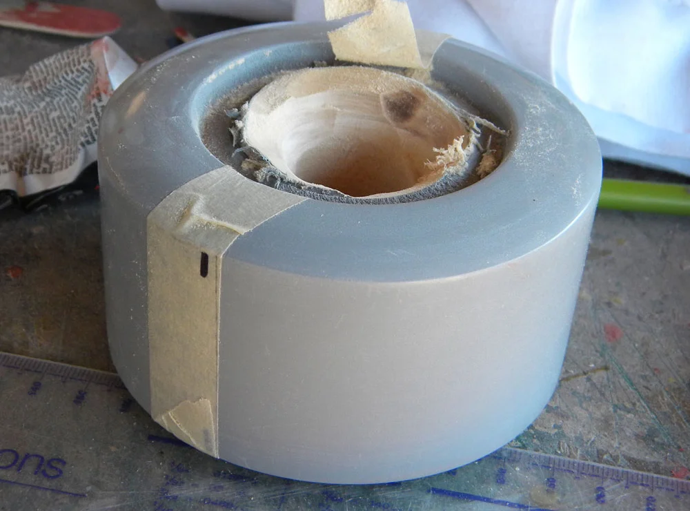 I drilled out the center, and marked the halfway point with tape.