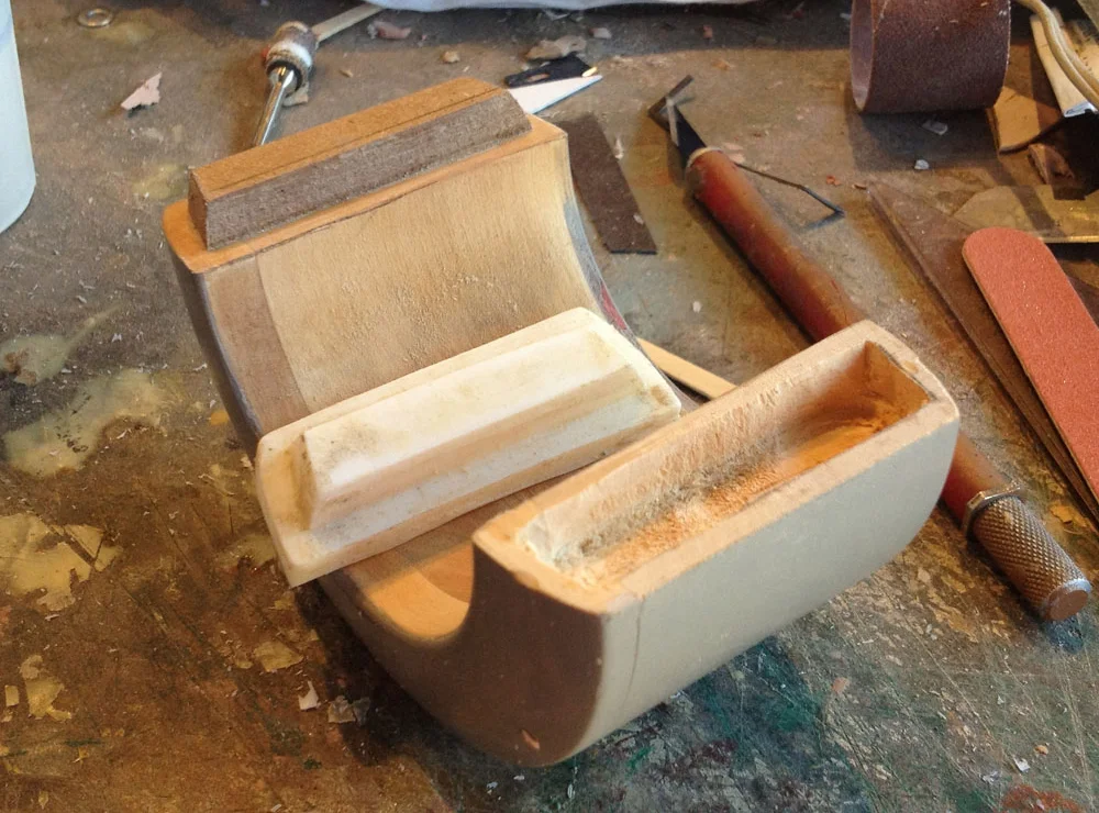 I poured some resin into the mold to make a copy of the key, then carved a hole in the other end to make the female end of the lock.