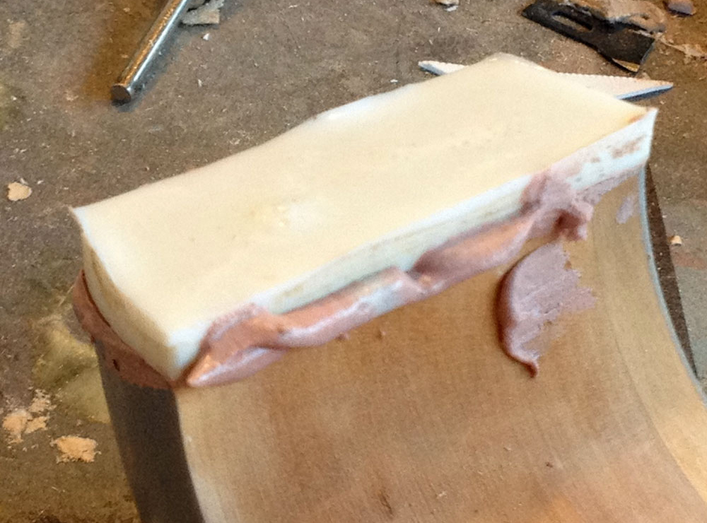  After glopping some Bondo into the hole, I pressed the resin key into it, making sure the edges were aligned. 