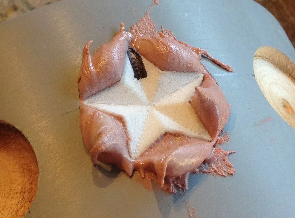 I mixed up a small quantity of Bondo, dropped it in the hole and then pressed the stamp into it.