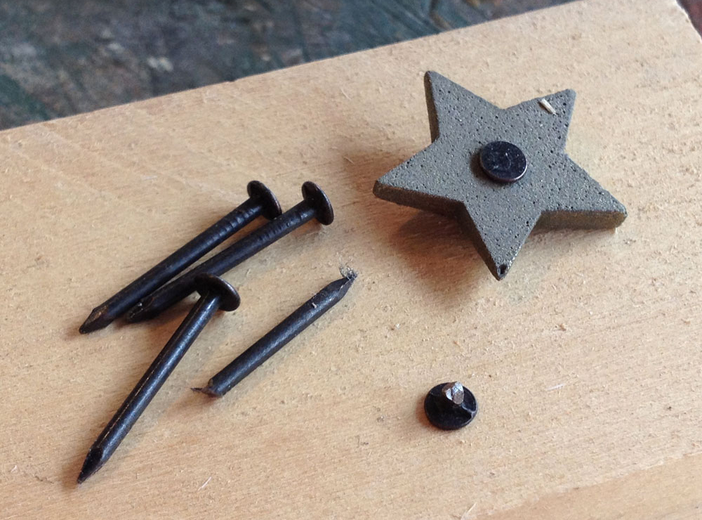  Each star had a hole drilled in the back so that a nail head could be glued in place. 