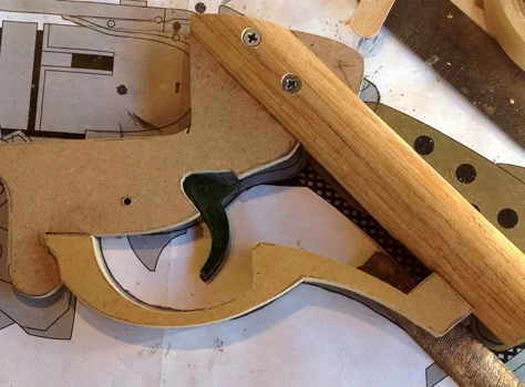 To frame up the pistol grip, I used 1/4″ MDF bolted to a walnut dowel. I cut the trigger from 1/4″ acrylic and the trigger guard was cut from 1/2″ MDF.