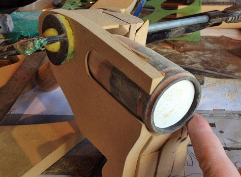  I started fleshing out the pistol grip with MDF, carving out a recess for the chamber cylinders. 