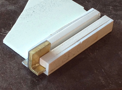  To make a sliding switch (for what we assumed was a safety), I glued two “L”-shaped pieces of metal together and made a styrene rail for it to slide along. 