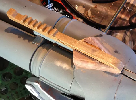 The top rail was made from wood and the joints were smoothed with Bondo.
