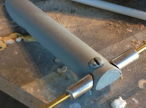 The lever would swivel on a brass rod between the two lower tips of the hinge. I used styrene plastic spacers inside the aluminum tubes so the pieces wouldn’t rattle.