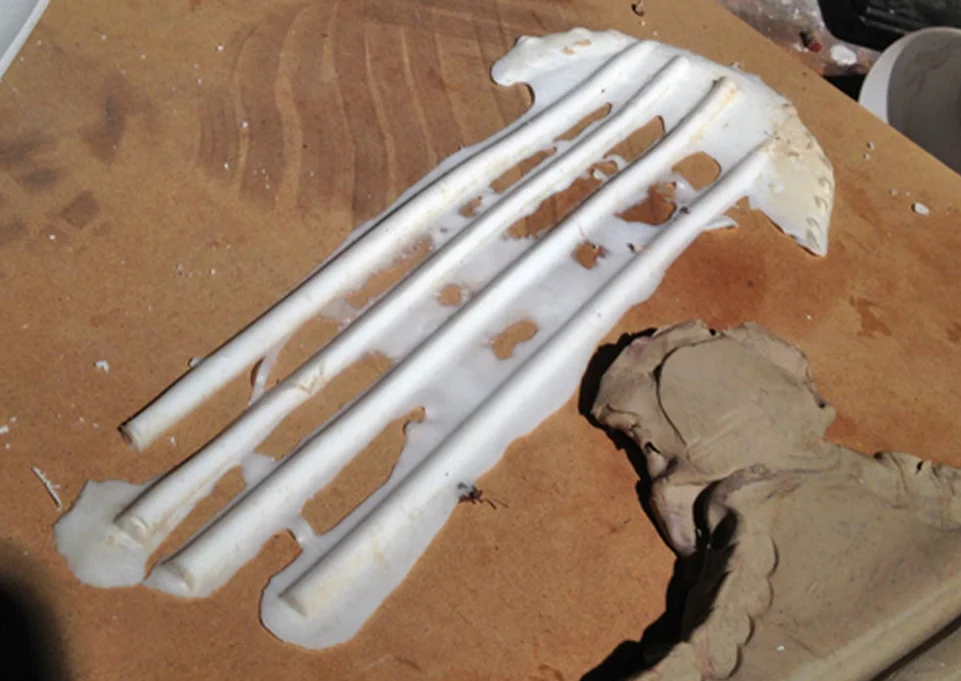I poured some SmoothCast 65D into the temporary mold and a few minutes later I had my half round ready for mounting!
