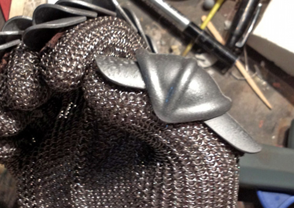  I took two longer finger plates, sewed them to a leather strip and then glued the assembly to the glove. I then sewed the thumb plate directly to the chainmail. 