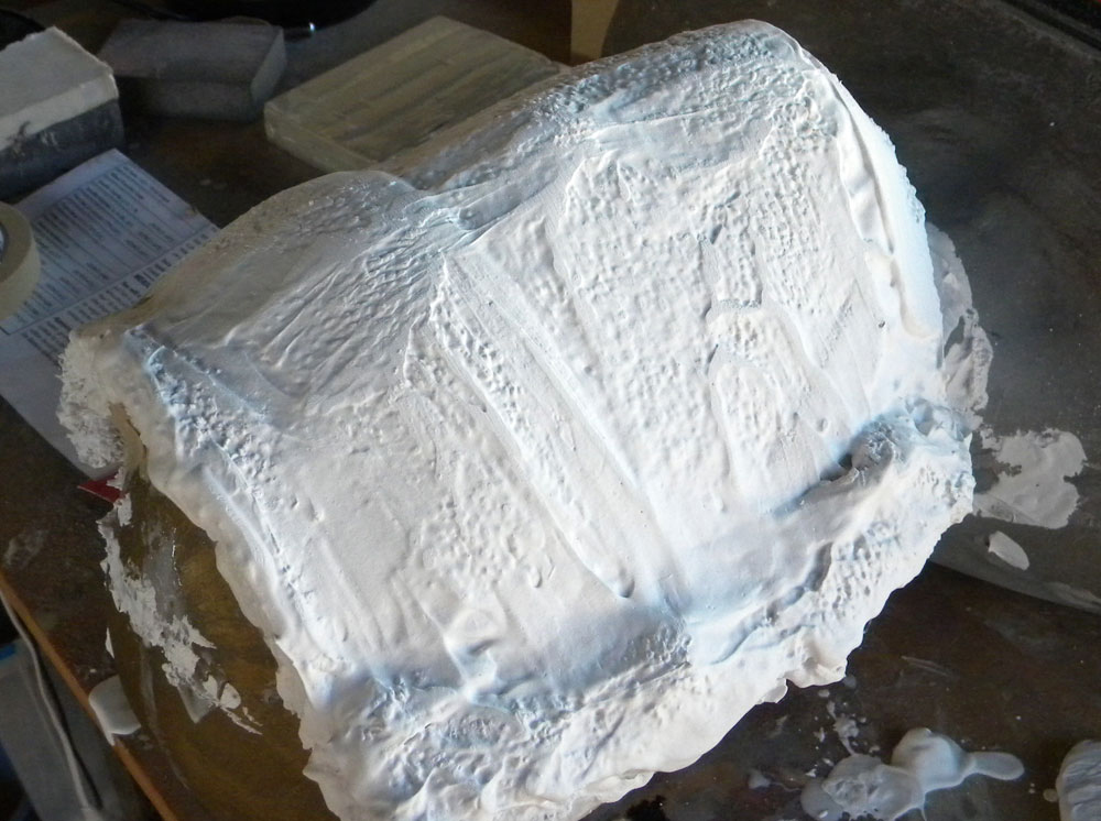 I soaked a cheap shop rag in plaster to make a mother mold over the silicone so that the mask can retain its proper shape.