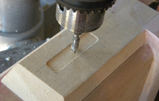  I chucked a router bit into drill press and carved out a decorative panel in the top. 