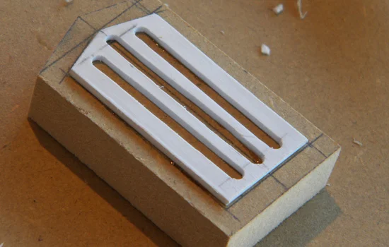 A detail block for the front plate was cut from MDF with a grill cut from styrene.