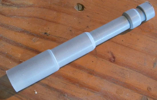 I lathed the piston that stretches from the front plate to the grip out of basswood.