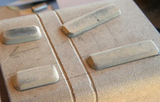 MDF details on top of the cowl. The seam lines were scribed on my Dremel router table.