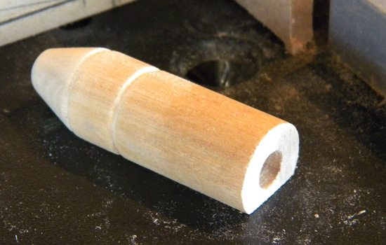  I lathed the (what I believe is a) range finder from a poplar dowel and flattened one side for attaching to the cowl. 