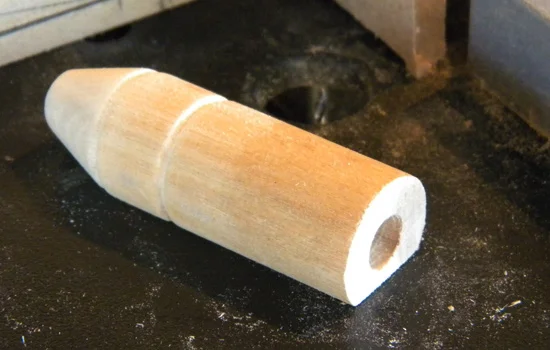 I lathed the (what I believe is a) range finder from a poplar dowel and flattened one side for attaching to the cowl.