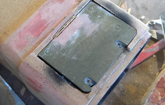 I used Bondo to cover the hinge.