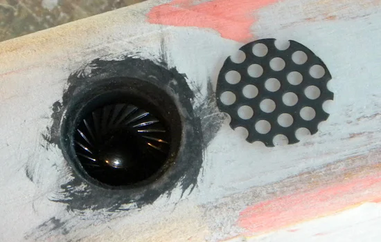 The speaker mounts under the gun behind the cowl. I cut a piece of metal grill from an old car stereo.
