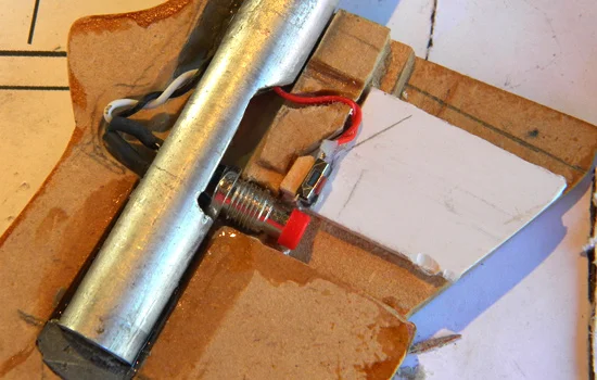 I used an aluminum tube to mount the pistol grip and ran the switch wiring down the center.
