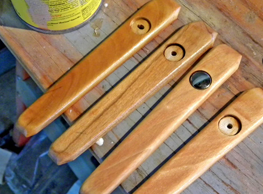 I cut grip panels from poplar, rounded the edges on the belt sander and drilled holes for the rivets. I found large snap covers that were right size for the rivets.