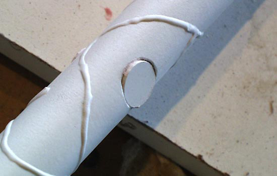 The shaft has three circles on each side of the shaft.. I drilled out a hole and then glued a plastic disc to each.