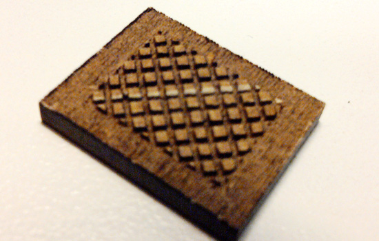The final component is the grip texture. I had the checkered pattern laser cut deeply out of the surface. I then used fine files to bevel each edge of the little squares so I wound up with a texture of fine, raised diamonds.