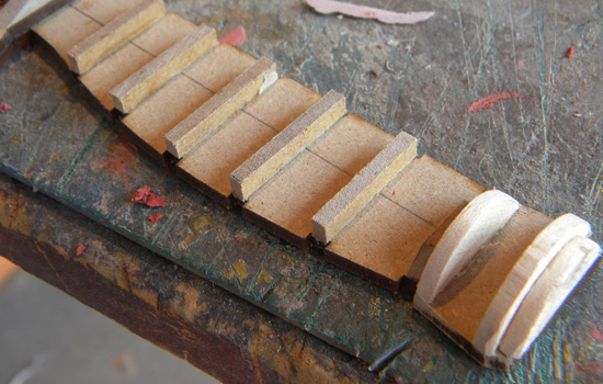  For the insets between grip panels, I glued on 1/8” balsa strips. I also used the balsa to frame out the pommel. 