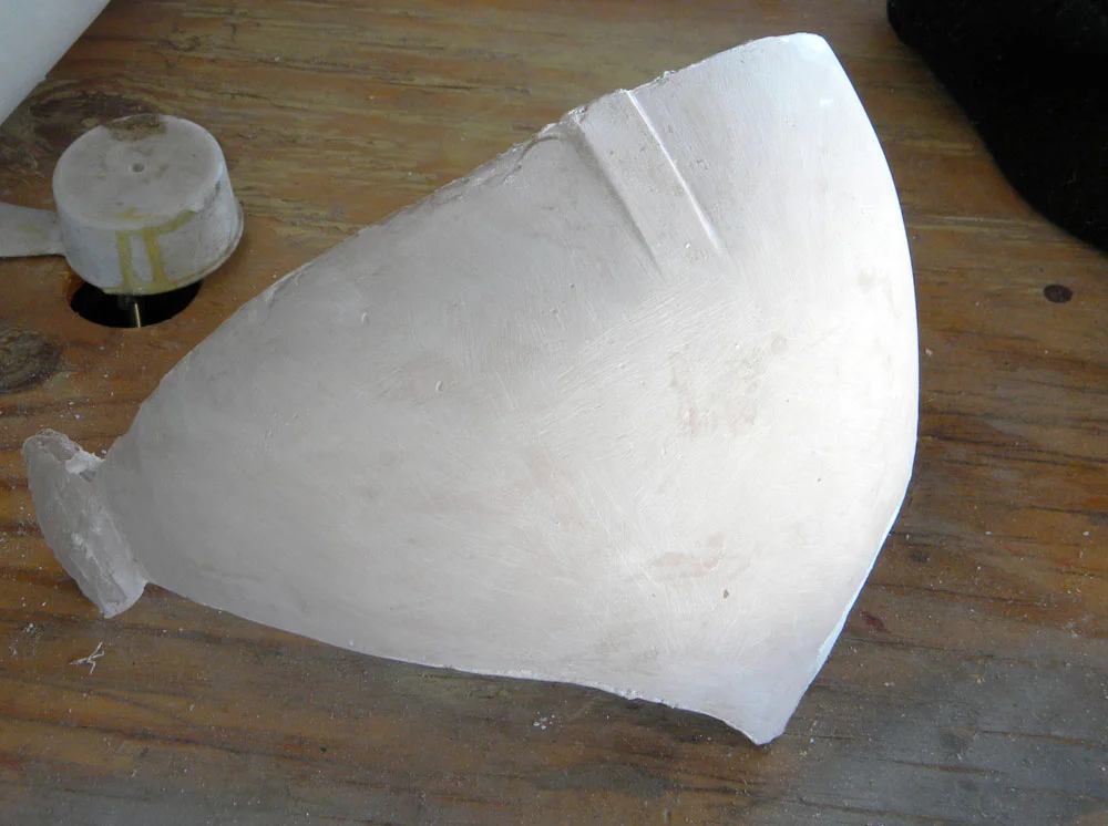 The Bondo lens was sanded smooth(er than the original sculpt), and glued to a wooden support.