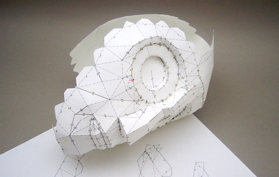After basing a 3D model on the animated character, I imported it into Pepakura and converted it into a paper model. I then printed it out and assembled it.