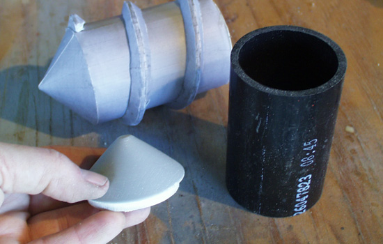 The shaft of the screw was made from a 2” ABS pipe. I lathed the end cap from a scrap of basswood. The paper model screw was assembled as a guide.