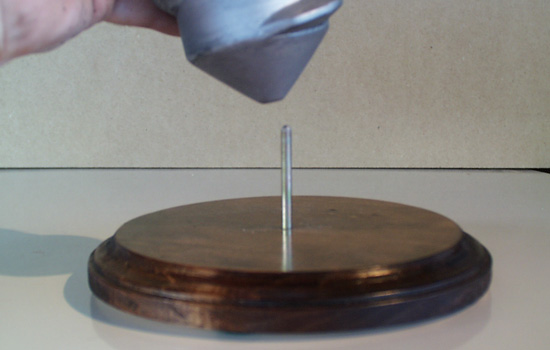 The secret of the stand…a nail is glued into the base that fits into a hole in the screw.