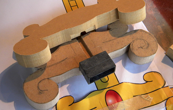 I cut hilt halves from 3/4″ MDF, cutting a channel for the steel support rod and blade collar.