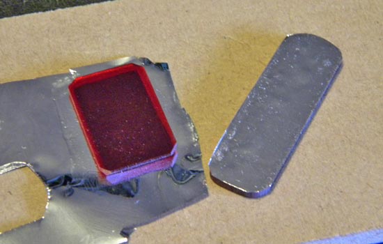 I backed the red acrylic buttons on the side with silver mylar to brighten their appearance.