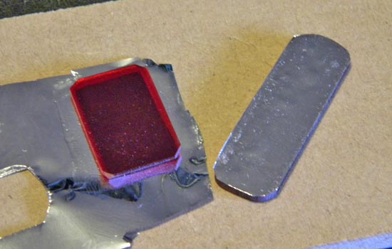  I backed the red acrylic buttons on the side with silver mylar to brighten their appearance. 