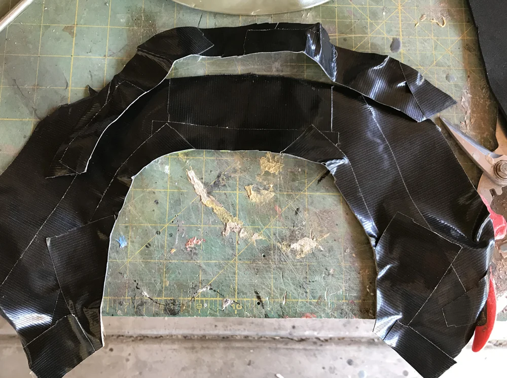 I cut the duct tape off and wound up with a pattern for the collar and top of the jacket.