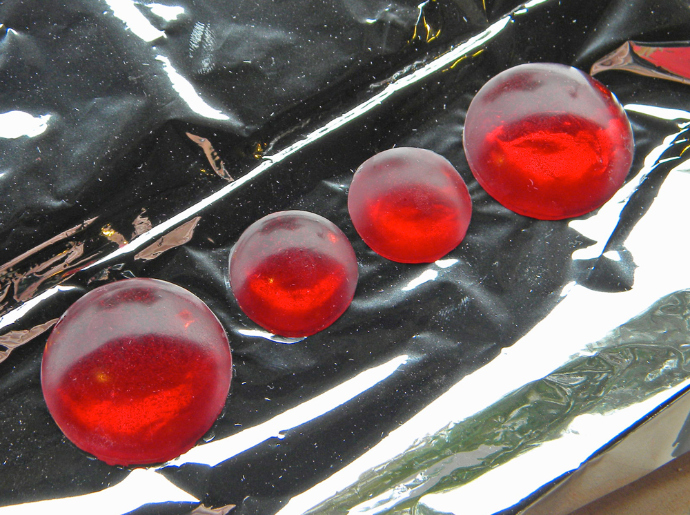  Resin gems with silver mylar glued to the back. The mylar brightens the appearance of the resin. 