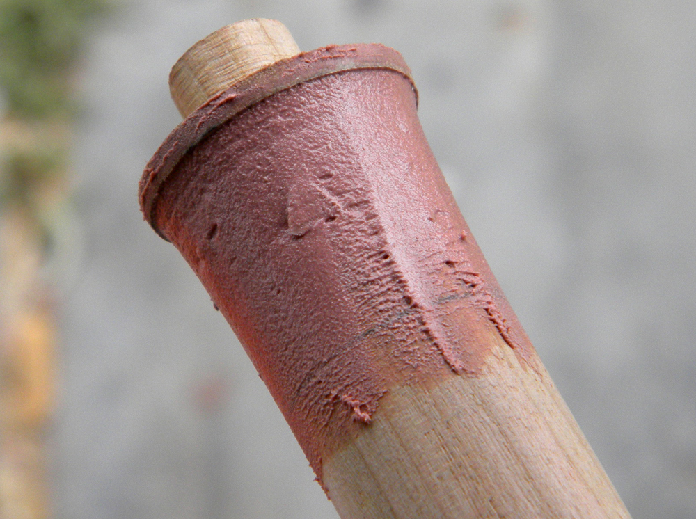 The staff was made from a 1″ oak dowel. I inserted a 1/2″ dowel in the end to attach the tip and flared both ends with Bondo, guided by a slightly larger MDF disc.