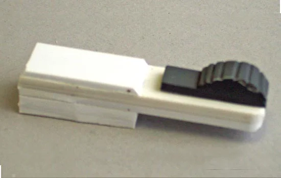 The switch slides into a slot on the bolt arm and locks into two positions.